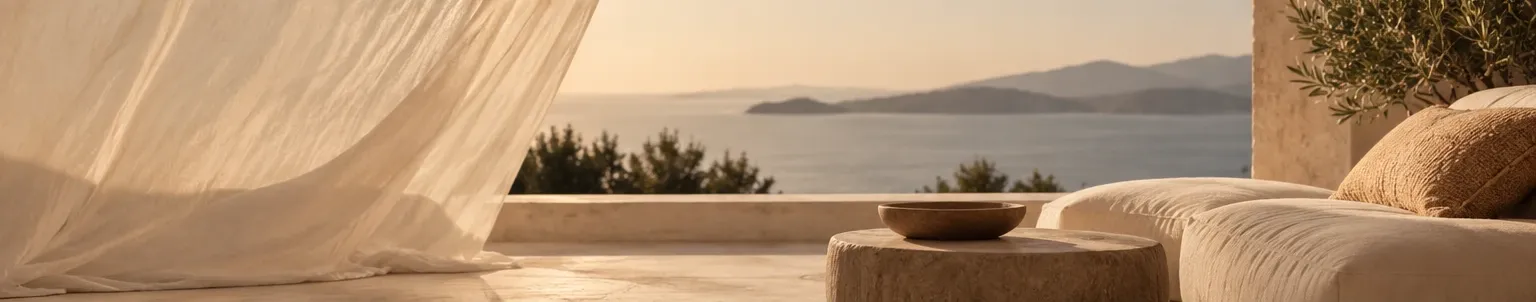 Linen curtain and a quiet terrace facing the sea at sunset